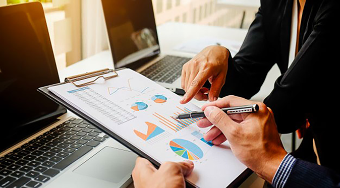 managers assessing graphs and results