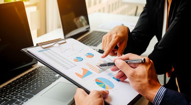 managers assessing graphs and results