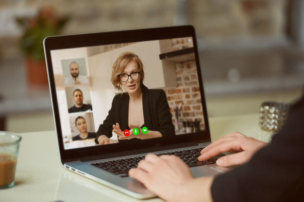 Supervisor in virtual meeting with remote team